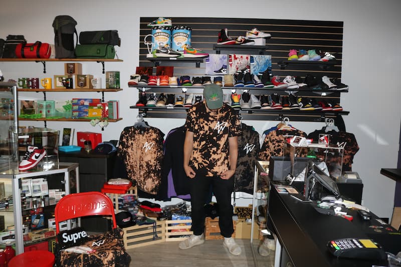 alliance white posing with his merch in an Edmonton store